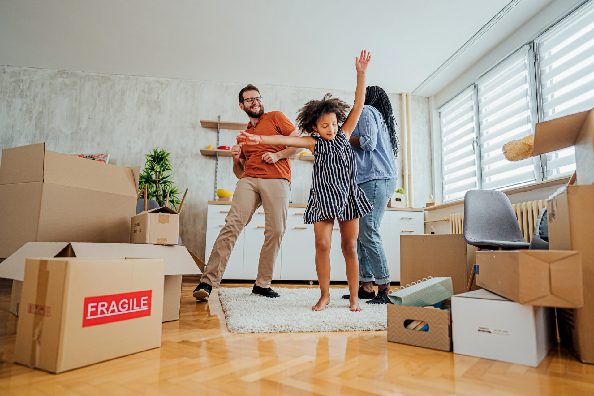 Family dancing in new home